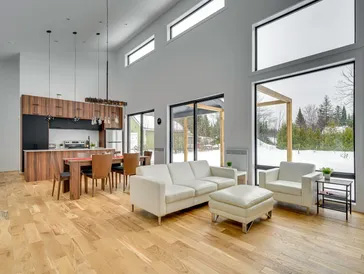 Salon moderne avec grandes fenêtres et parquet